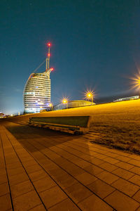 Illuminated building against sky at night