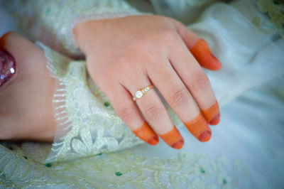 Midsection of bride with henna tattoo