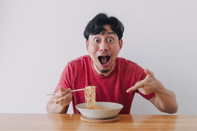 Portrait of young man eating food