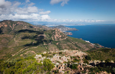 Scenic view of sea and mountains against sky