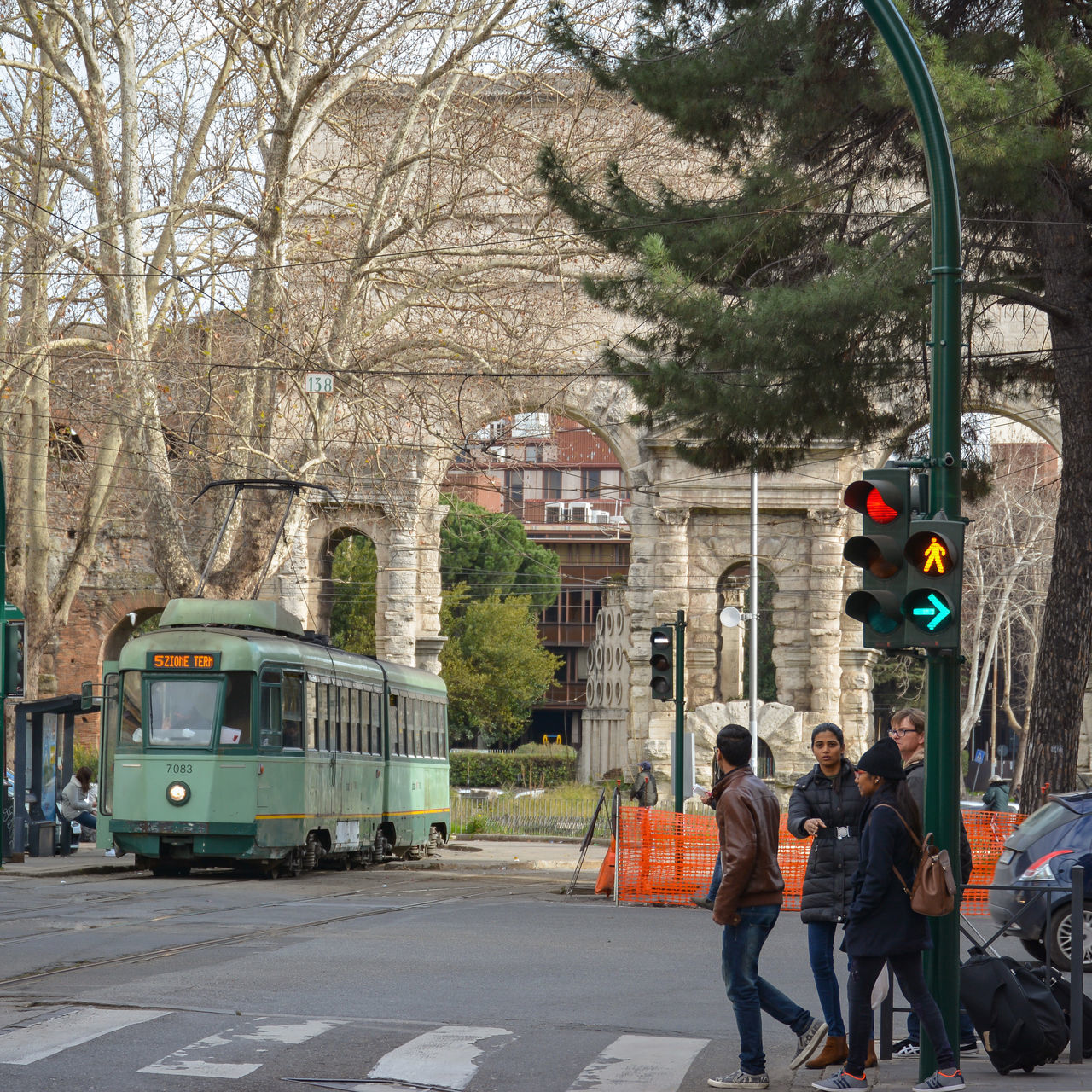 PEOPLE ON ROAD AGAINST BUILDINGS