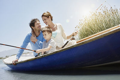 People on boat against sky