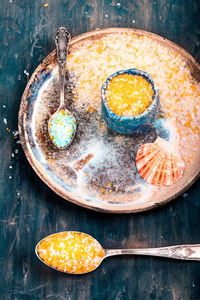 High angle view of sugar and seashell in plate on table