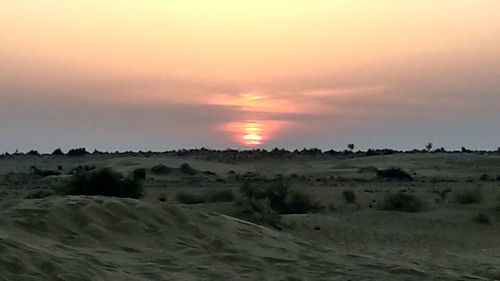 Scenic view of landscape against sky during sunset