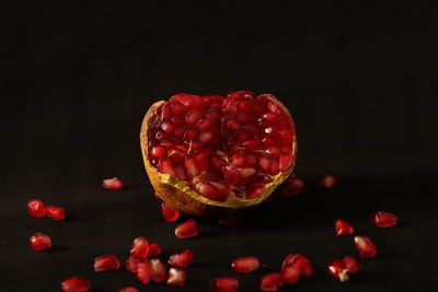 Close-up of strawberries on table against black background