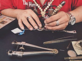 Hands repairing wristwatch