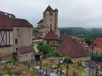 Old buildings in town against sky