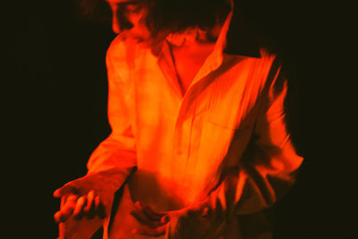 Close-up of woman against red light