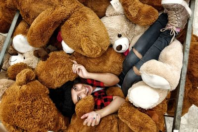 High angle view of woman amidst stuffed toys 