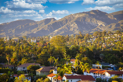 High angle view of townscape and mountains against sky