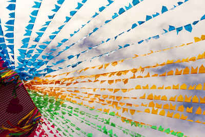 Low angle view of colorful flags against sky