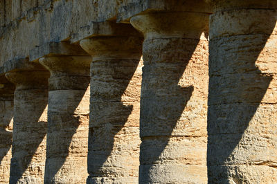 Shadow of people on stone wall