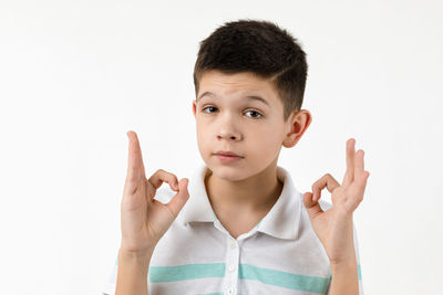 Portrait of young woman gesturing against white background