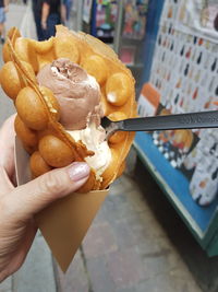 Close-up of hand holding ice cream