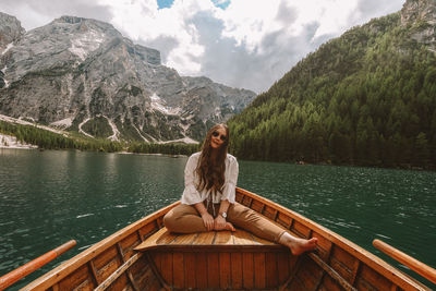 Woman sitting on boat at lake 