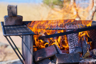 Fire in a rusty vintage grill outdoor on the beach of the sea.