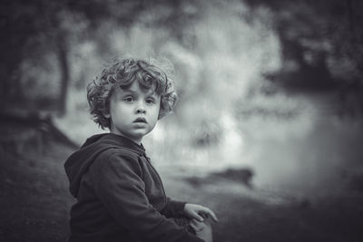 Portrait of boy standing on field