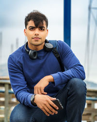 Portrait of young man sitting outdoors