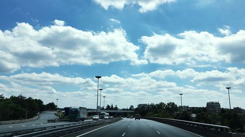 View of highway against cloudy sky