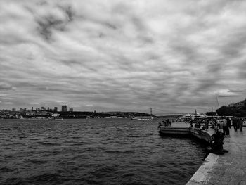 Bridge over river in city against sky