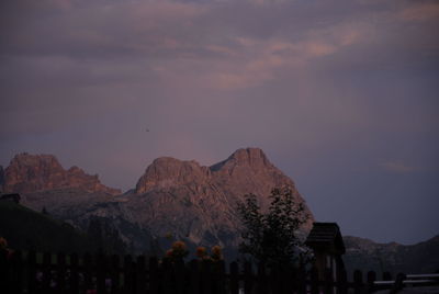 Group of people on mountain range at sunset