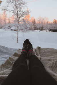 Low section of man relaxing on snow