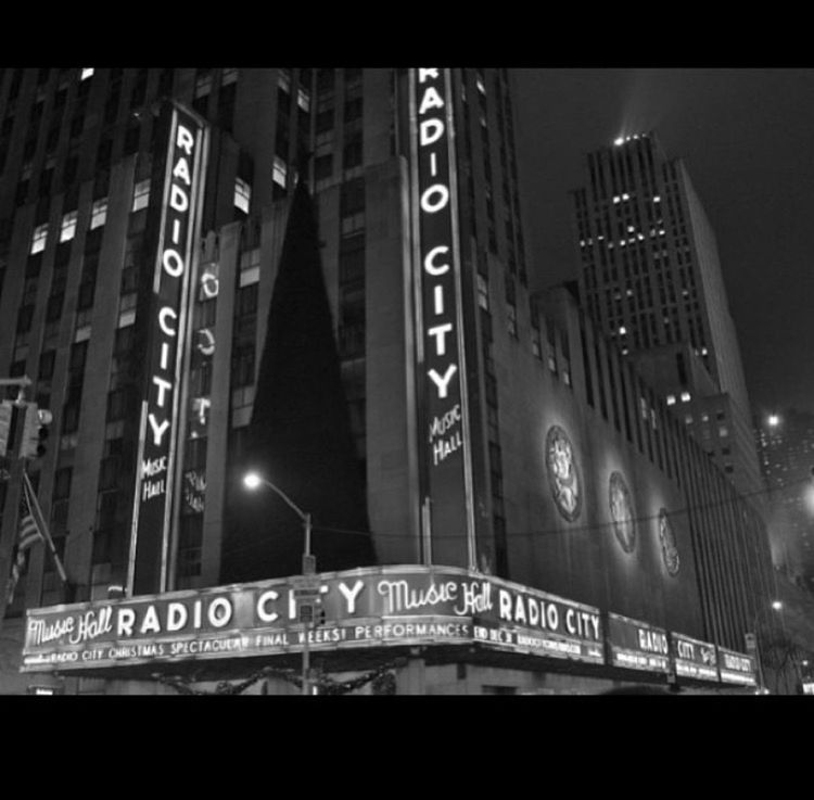 illuminated, night, text, architecture, built structure, communication, low angle view, western script, building exterior, city, modern, information sign, capital letter, building, city life, lighting equipment, no people, information, indoors, sign