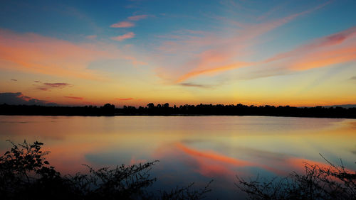 Scenic view of lake against romantic sky at sunset