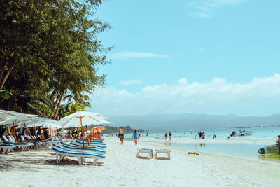 People at beach against sky at boracay during summer