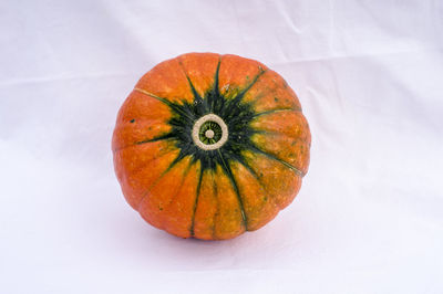 Close-up of pumpkin against orange background