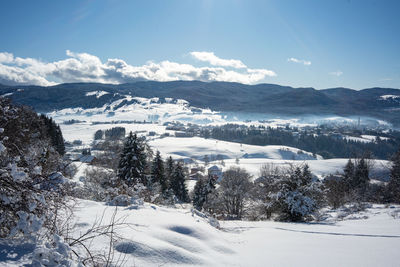 Scenic view of snow covered mountains against sky