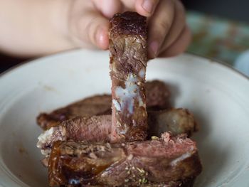 Close-up of person preparing food in plate