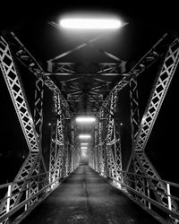 Illuminated bridge at night