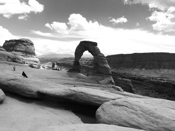 Rock formation on shore against sky