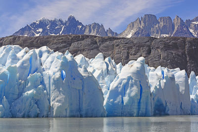 Ice, rocks, and mountains by the grey glacier in torres del paine national park in patagonian, chile