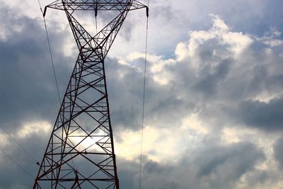 Low angle view of electricity pylon against sky