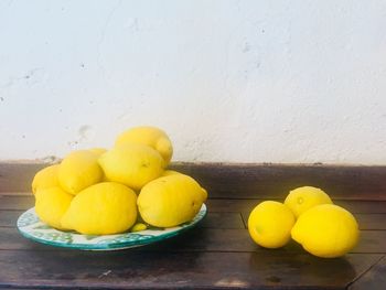 Close-up of lemons in plate on table