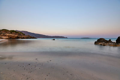 Scenic view of sea against clear sky during sunset