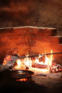 Close-up of fire on log at night
