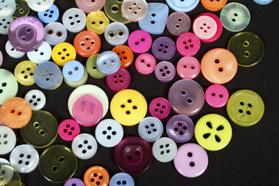 Close-up of multi colored buttons on table