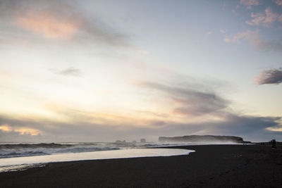 Scenic view of beach against sky during sunset