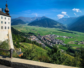 Scenic view of mountains and buildings against sky