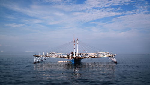 Sailboat sailing in sea against sky