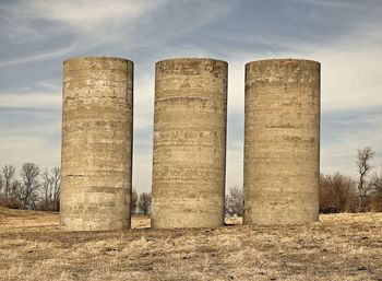 Low angle view of columns on field against sky