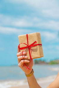 Cropped hand of woman holding gift