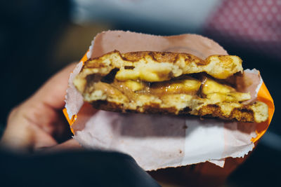 Close-up of hand holding burger