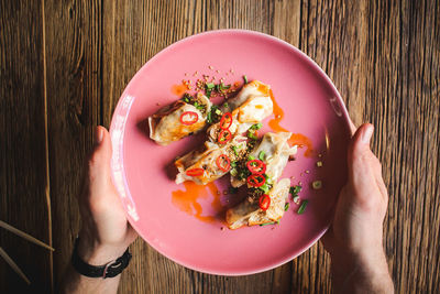 Directly above shot of person holding breakfast on table