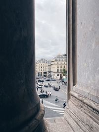 View of paris cityscape and city life through architectural columns with copy space 