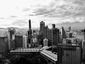 View of skyscrapers against cloudy sky