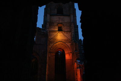 Low angle view of bell tower at night